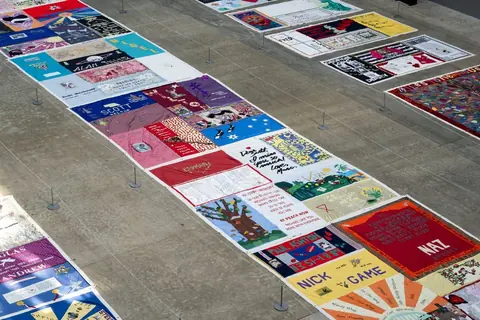 UK AIDS Memorial Quilt 于 2025 年在 Tate Modern 涡轮大厅完整铺展的资料照片，并非本次格拉斯哥现场